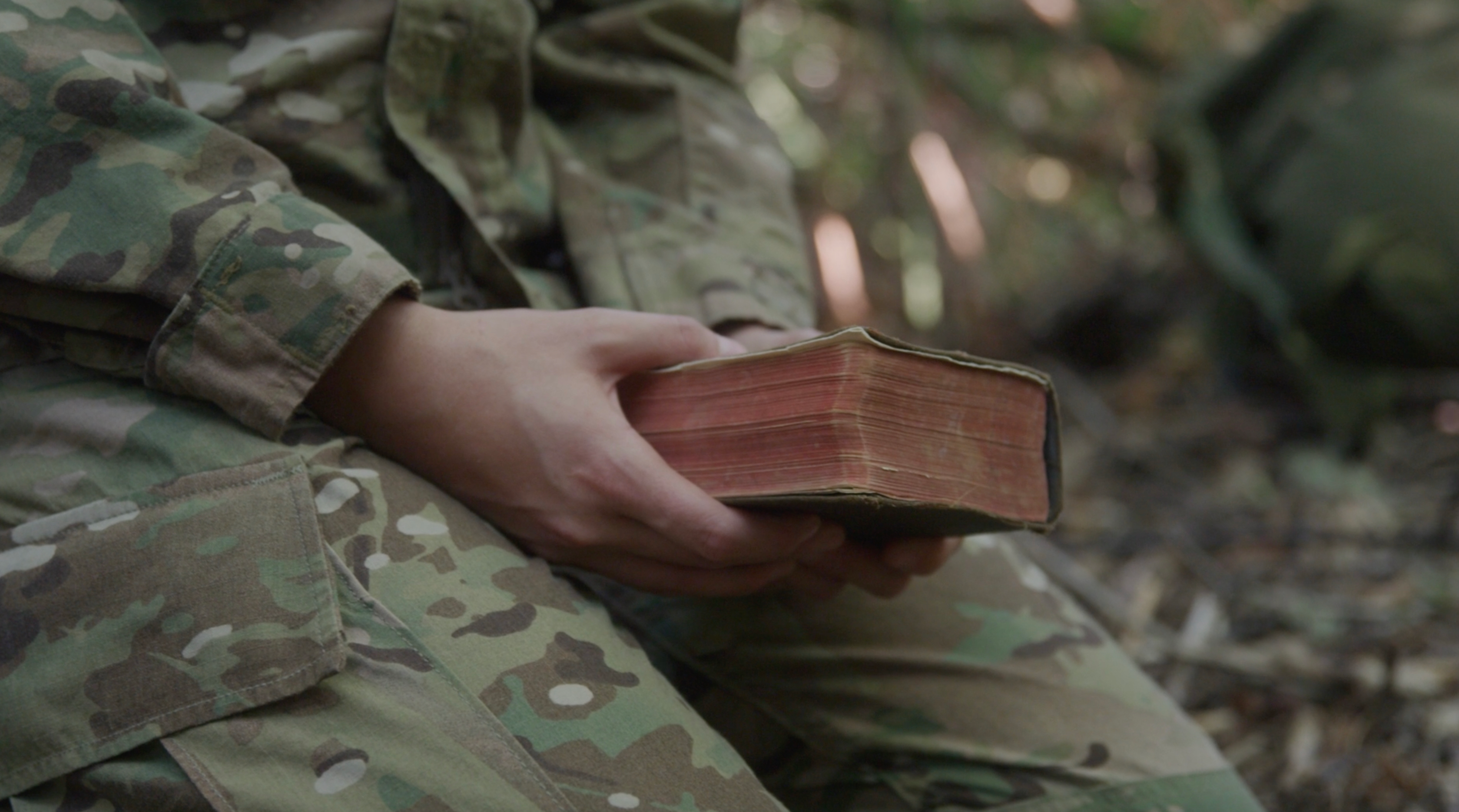 Service member holding a Bible